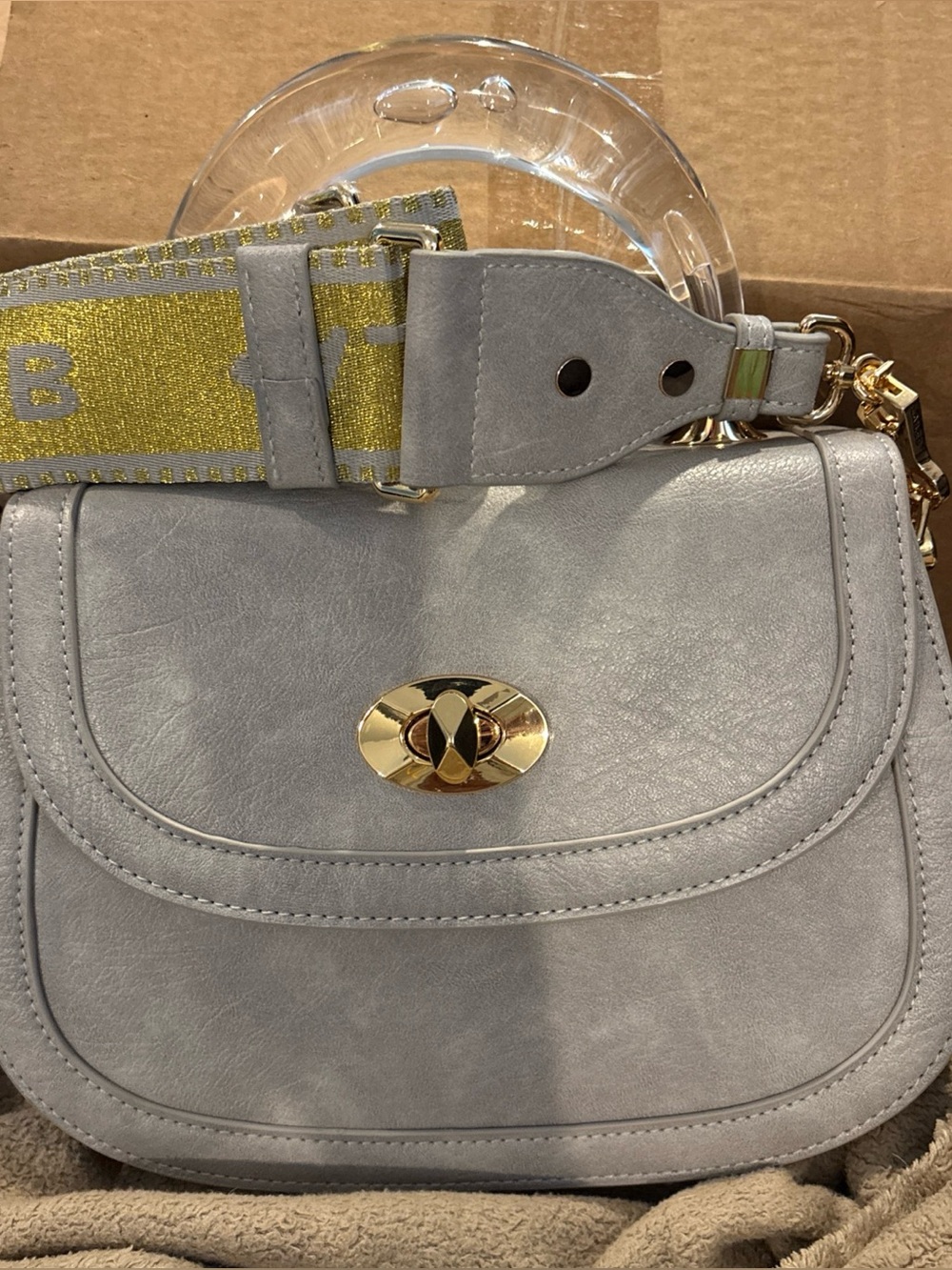 Light Gray Crossbody Bag with Gold Hardware and Detachable Strap